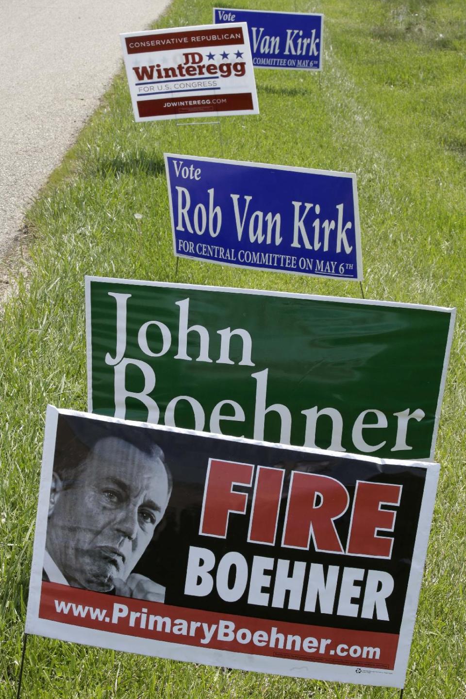 Campaign signs for Speaker John Boehner and one of his opponents, J.D. Winteregg, are posted on a road leading to a polling location, Tuesday, May 6, 2014, in West Chester, Ohio. Statewide a number of incumbent Republican lawmakers in Ohio face challengers in Tuesday's primary as they try to keep their seats this fall in the Statehouse and the U.S. Capitol. (AP Photo/Al Behrman)