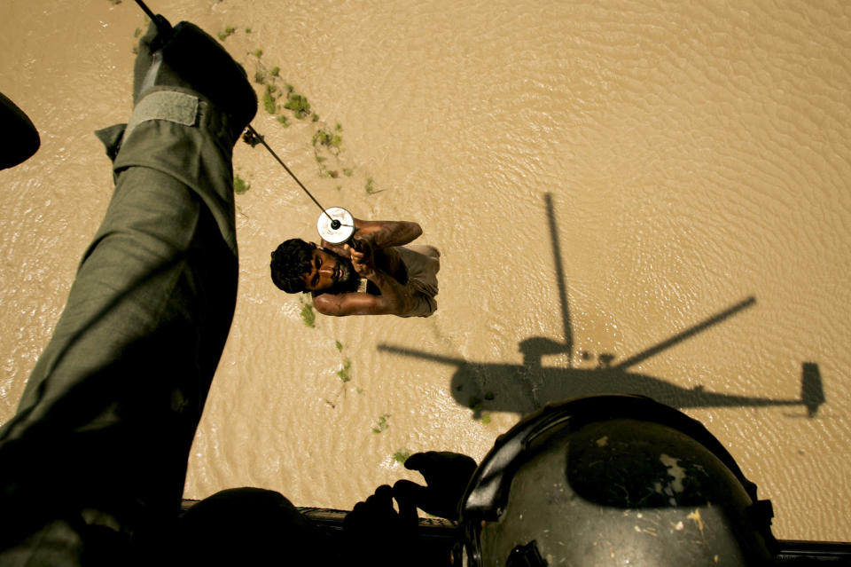 <p>A villager is rescued by a Pakistani navy helicopter from a flooded area of Ghaus Pur near Sukkur, in Pakistan’s Sindh province, Aug. 11, 2010. (AP Photo/Shakil Adil) </p>