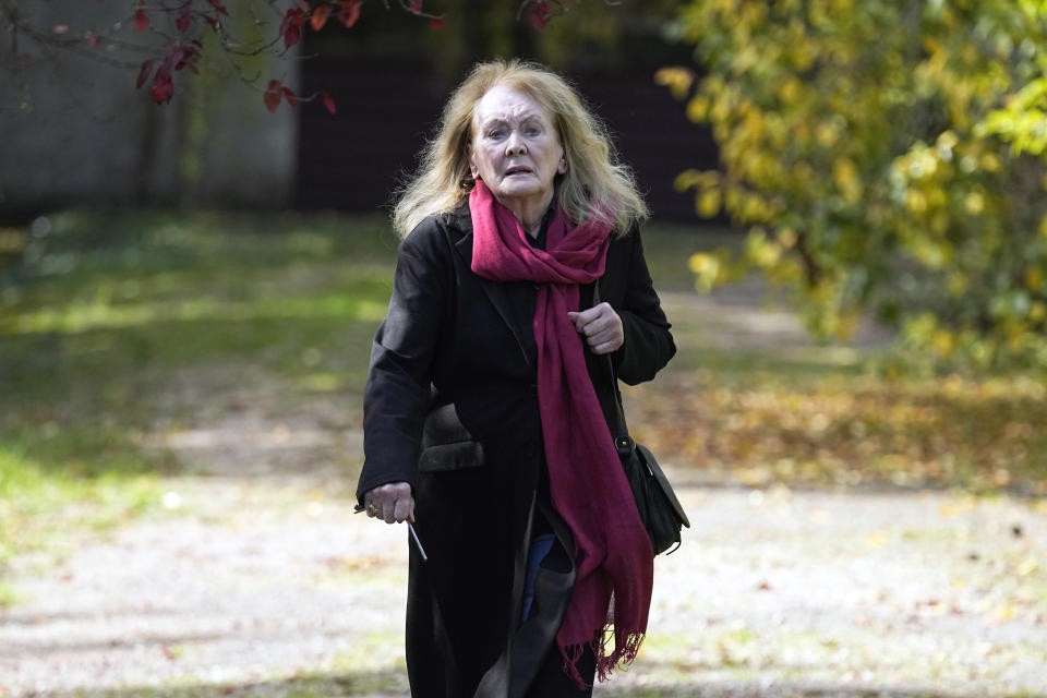 French author Annie Ernaux leaves her home in Cergy-Pontoise, outside Paris, Thursday, Oct. 6, 2022. The 82-year-old was cited for "the courage and clinical acuity with which she uncovers the roots, estrangements and collective restraints of personal memory," the Nobel committee said. (AP Photo/Michel Euler)