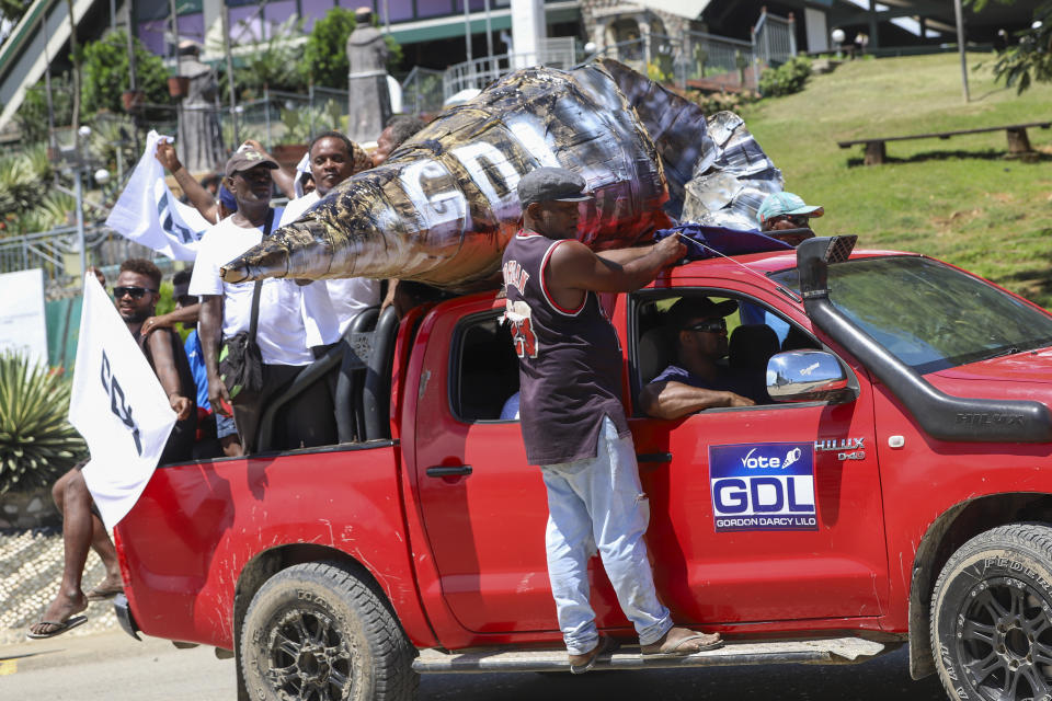 Locals react as they participate in a candidates parade in the capital Honiara, Solomon Islands, Monday, April 15, 2024. The country in which China has gained most influence in the South Pacific, Solomon Islands, goes to the polls on Wednesday in an election that could shape the region's future. (AP Photo/Charley Priringi)