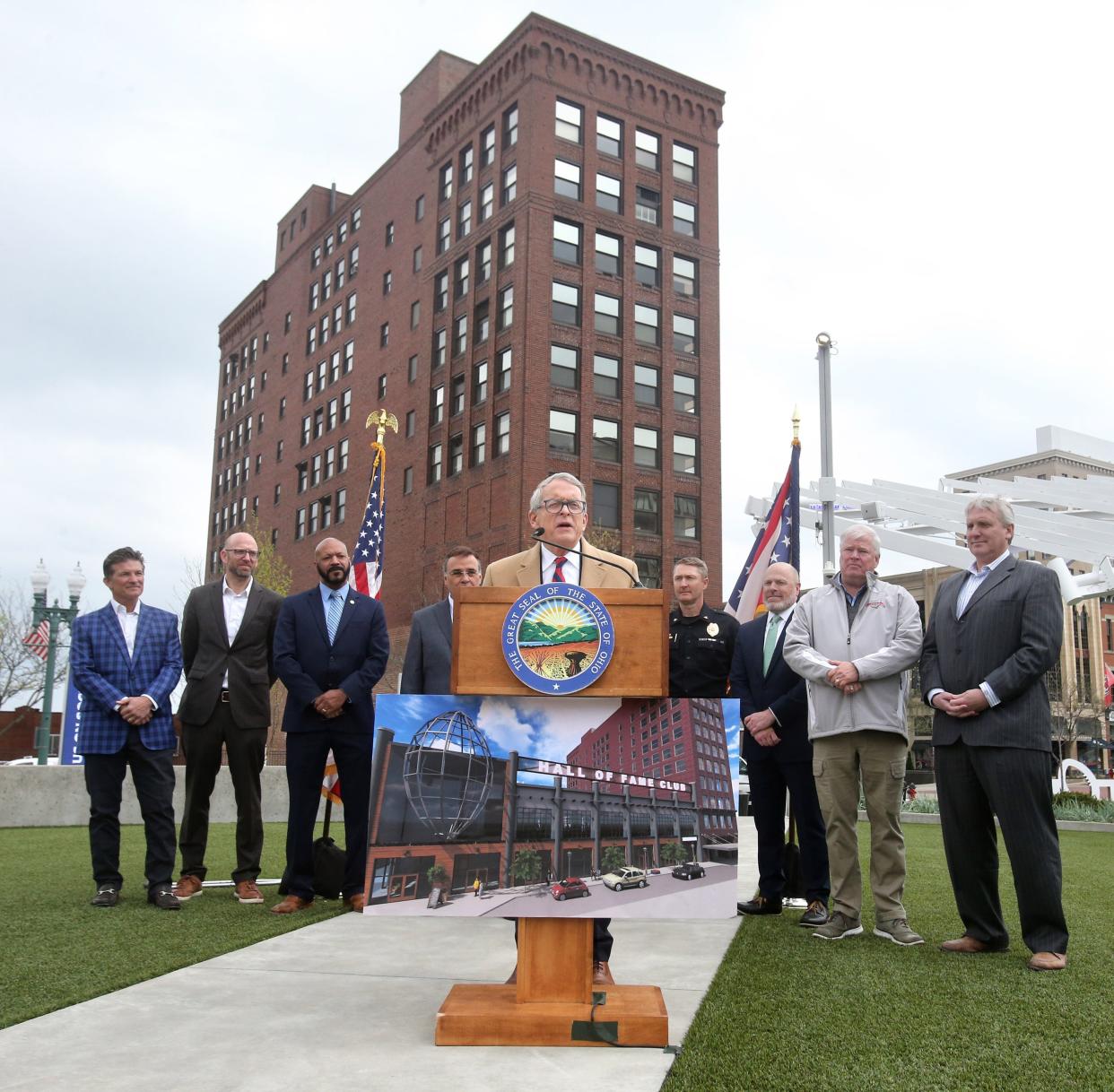 Ohio Gov. Mile DeWine speaks with the historic Renkert Building behind him in April in Canton.