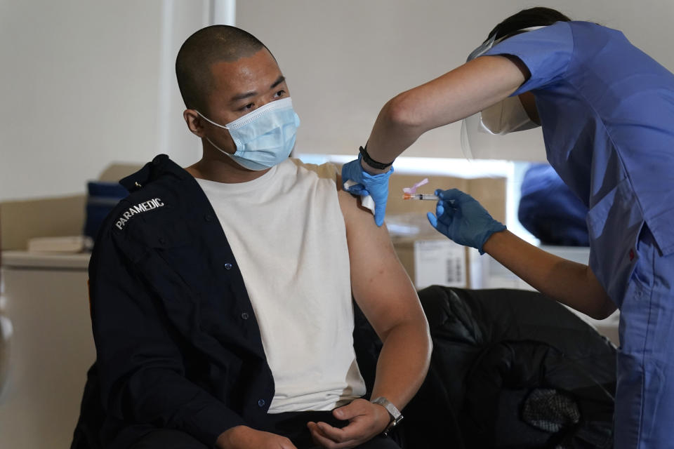 Medical personnel prepare a coronavirus vaccine against COVID-19 to be administered to New York City firefighter emergency medical services personnel at the FDNY Fire Academy in New York, Wednesday, Dec. 23, 2020. (AP Photo/Seth Wenig)