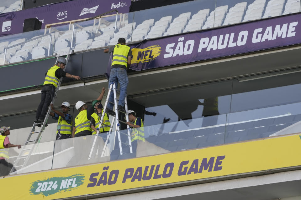 Men work to prepare the Soccer Neo Química Arena in Sao Paulo, Wednesday, Sept. 4, 2024, as Brazil prepares to host its first ever NFL match on Sept. 6, 2024, between the Green Bay Packers and the Philadelphia Eagles. (AP Photo/Andre Penner)