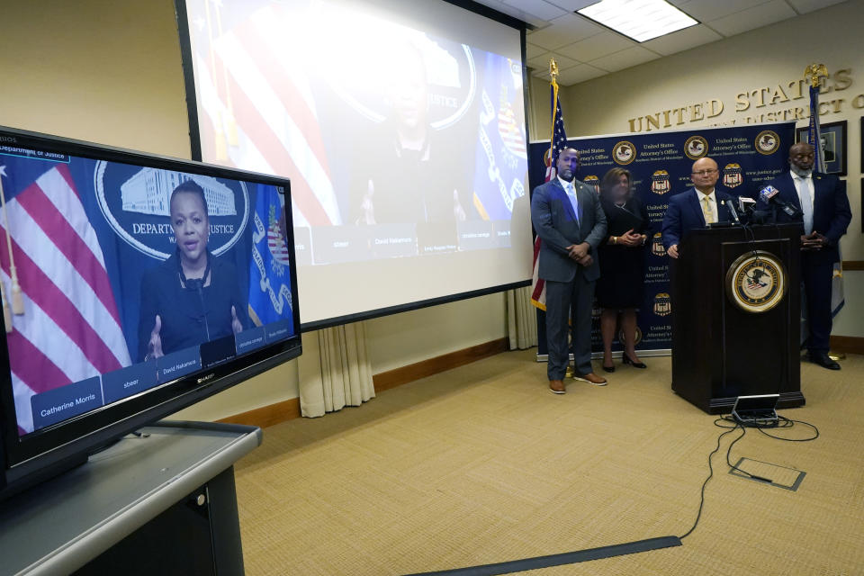 Assistant Attorney General for Civil Rights at the U.S. Department of Justice, Kristen Clarke, left, addresses reporters from a monitor during a news conference following a court hearing where six white former Mississippi law enforcement officers plead guilty to federal civil rights offenses in federal court, in Jackson, Miss., Thursday, Aug. 3, 2023. The six former officers who called themselves the “Goon Squad” pleaded guilty to a racist assault on two Black men in a home raid that ended with an officer shooting one man in the mouth. (AP Photo/Rogelio V. Solis)