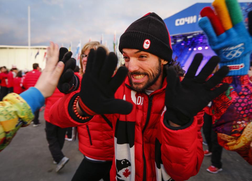 Charles Hamelin, a member of Canada's short track speed skating team, greets the audience during a welcoming ceremony for the team in the Athletes Village, at the Olympic Park ahead of the 2014 Winter Olympic Games in Sochi February 5, 2014. REUTERS/Shamil Zhumatov (RUSSIA - Tags: SPORT OLYMPICS SPEED SKATING)