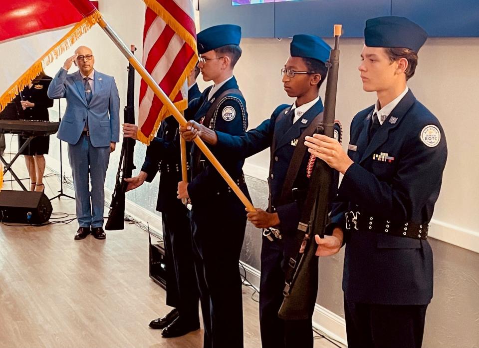 Palm Bay Mayor Medina salutes as members of the Satellite Beach High School ROTC present the colors at the 11th annual Space Coast Prayer Breakfast.