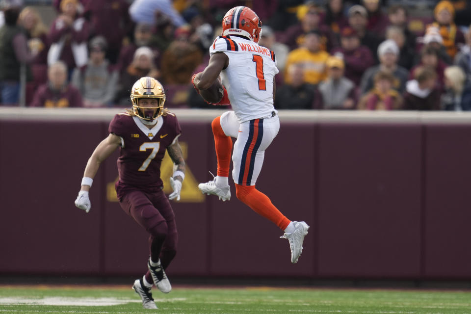 Illinois wide receiver Isaiah Williams (1) catches a pass for a first down as Minnesota defensive back Aidan Gousby (7) defends during the first half of an NCAA college football game Saturday, Nov. 4, 2023, in Minneapolis. (AP Photo/Abbie Parr)