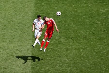 Football Soccer - Switzerland v Poland - EURO 2016 - Round of 16 - Stade Geoffroy-Guichard, Saint-Étienne, France - 25/6/16Poland's Robert Lewandowski in action with Switzerland's Fabian Schar REUTERS/Max Rossi Livepic