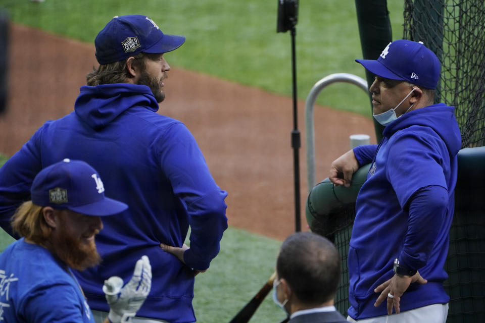 Los Angeles Dodgers manager Dave Roberts talks with starting pitcher Clayton Kershaw during batting practice before Game 2 of the baseball World Series against the Tampa Bay Rays Wednesday, Oct. 21, 2020, in Arlington, Texas. (AP Photo/Sue Ogrocki)