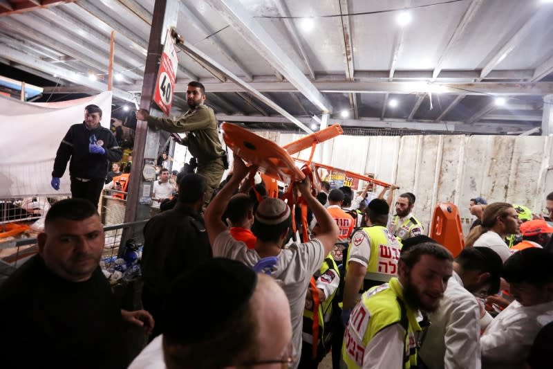 FILE PHOTO: Medics and rescue workers carry stretchers at the Lag B'Omer event in Mount Meron, northern Israel, where fatalities were reported among the thousands of ultra-Orthodox Jews gathered