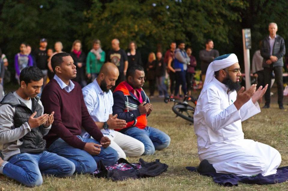 Mufti Zeeyad Ravat (R), a muslim leader from Melbourne, leads a prayer at the Deans Ave memorial, near Al Noor mosque in Christchurch, New Zealand on March 19, 2019.