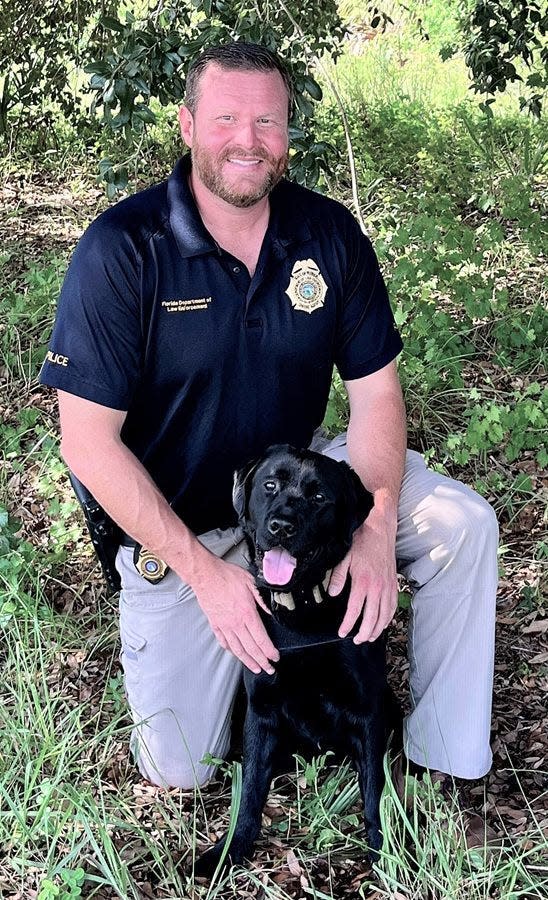 Cache and his handler, Justin Gilmer, a special agent with the Florida Department of Law Enforcement.