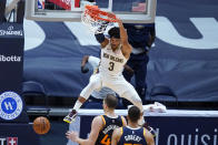 New Orleans Pelicans guard Josh Hart (3) slam-dunks over Utah Jazz center Rudy Gobert and forward Bojan Bogdanovic in the final seconds of the second half of an NBA basketball game in New Orleans, Monday, March 1, 2021. (AP Photo/Gerald Herbert)