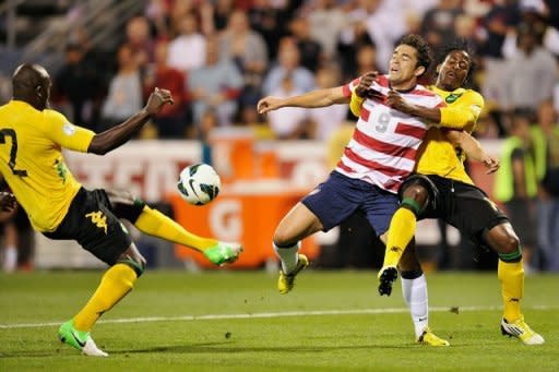 Herculez Gomez (C) of the US team is held back by Jamaica's Rodolph Austin (R), as Nyron Nosworthy takes control of the ball during their World Cup qualifying match on September 11. The US football team got their qualifying campaign back on track with a 1-0 win