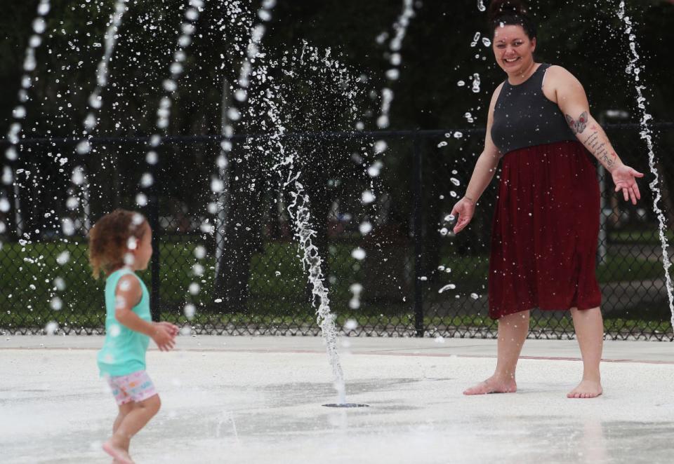 Zara Tinajero, 2, and her mother, Marissa Tinajero enjoy the water park at Veterans Park in Lehigh Acres on Tuesday May, 14, 2019. Temperatures were hovering in the mid 80's. 