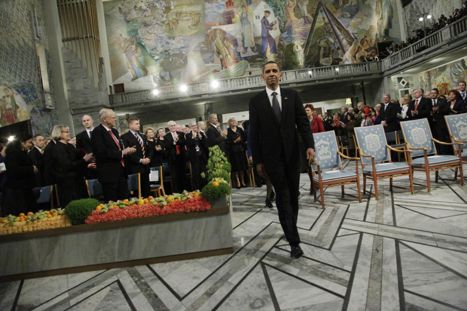 FILE - US President and Nobel Peace Prize laureate Barack Obama enters the Nobel Peace Prize ceremony at City Hall in Oslo, Thursday, Dec. 10, 2009. The Nobel Prizes project an aura of being above the political fray, focused solely on the benefit of humanity. But the peace and literature awards, in particular, are sometimes accused of being politicized. Critics question whether winners are selected because their work is truly outstanding or because it aligns with the political preferences of the judges. (AP Photo/John McConnico, File)