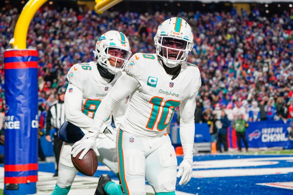 Miami Dolphins wide receiver Tyreek Hill (10) reacts to scoring a touchdown against the Buffalo Bills during the second half Dec. 17, 2022 at Highmark Stadium in Orchard Park, New York.