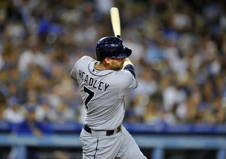 San Diego Padres third baseman Chase Headley (7) hits a single in the seventh inning against the Los Angeles Dodgers at Dodger Stadium. July 12, 2014; Los Angeles, CA, USA; Gary A. Vasquez-USA TODAY Sports