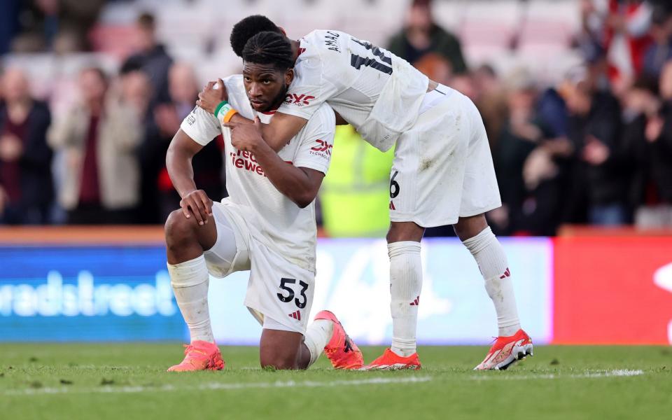 Amad Diallo embraces Willy Kambwala at the final whistle.