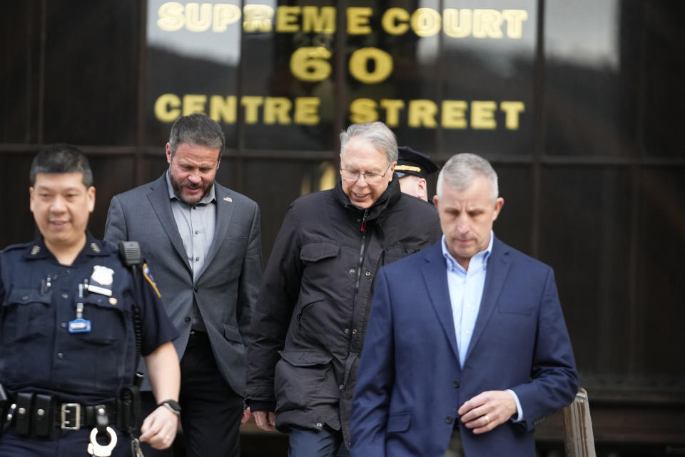 CORRECTS LOCATION OF LAPIERRE TO CENTER RIGHT INSTEAD OF AT LEFT - Wayne LaPierre, center right, CEO of the National Rifle Association, leaves New York State Supreme Court as a jury continues deliberations during a trial, Wednesday, Feb. 21, 2024, in New York. (AP Photo/Frank Franklin II)