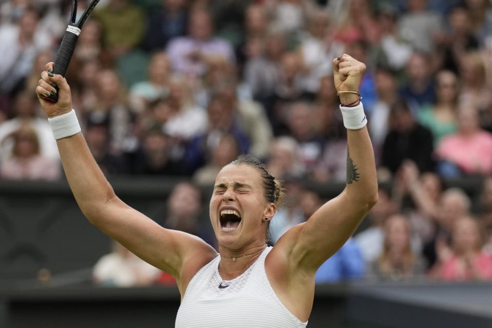 Aryna Sabalenka of Belarus celebrates after defeating Tunisia's Ons Jabeur during the women's singles quarterfinals match on day eight of the Wimbledon Tennis Championships in London, Tuesday, July 6, 2021. (AP Photo/Kirsty Wigglesworth)