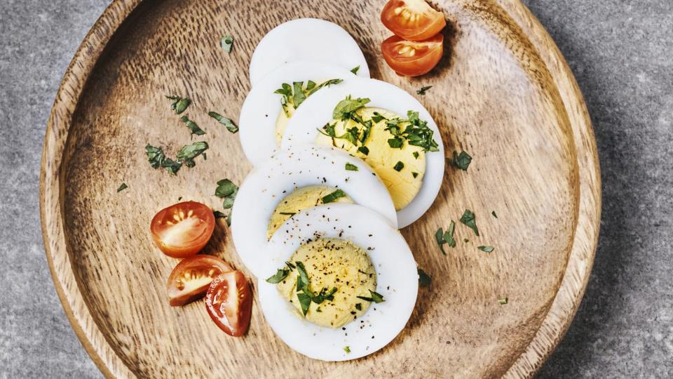 air-fryer-hard-boiled-eggs-hack: hard-boiled eggs with herbs and tomato