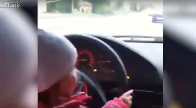 A child reportedly sits on their father's lap at the wheel of a car. Source: LiveLeak