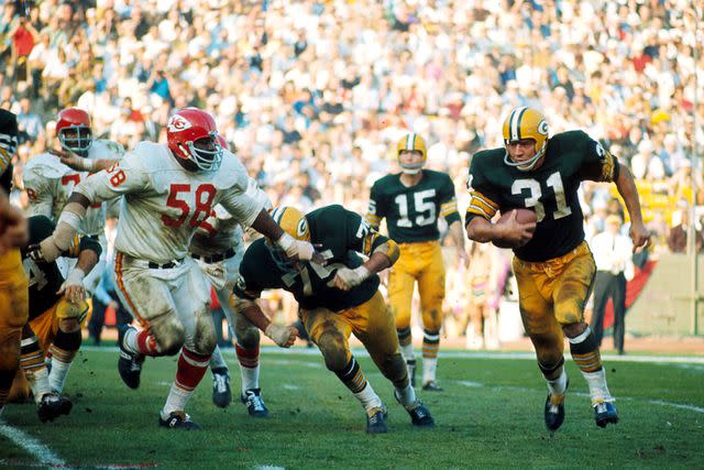 James Flores / Getty Images Green Bay Packers Hall of Fame fullback Jim Taylor (31) turns the corner with Kansas City Chiefs defensive tackle Andrew Rice (58) trying to catch up during Super Bowl I, a 35-10 Packers victory on January 15, 1967