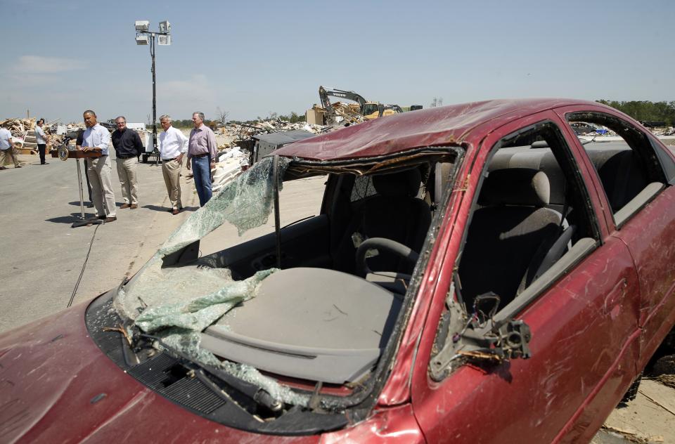 Amid the wreckage, U.S. President Barack Obama speaks as he visits the tornado devastated town of Vilonia, Arkansas May 7, 2014. The tornadoes were part of a storm system that blew through the Southern and Midwestern United States earlier this week, killing at least 35 people, including 15 in Arkansas. Obama has already declared a major disaster in Arkansas and ordered federal aid to supplement state and local recovery efforts. (REUTERS/Kevin Lamarque)