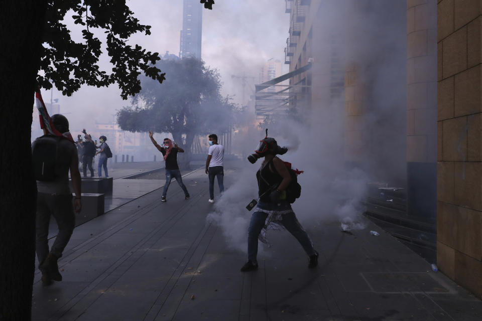 Anti-government protesters clash with riot police during ongoing protests against the Lebanese government, in downtown Beirut, Lebanon, Saturday, June 6, 2020. Hundreds of Lebanese demonstrators gathered in central Beirut Saturday, hoping to reboot nationwide anti-government protests that began late last year amid an unprecedented economic and financial crisis. (AP Photo/Bilal Hussein)