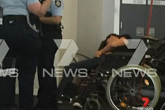 An admittedly drunken Hackett was pictured in a wheel chair after being taken into custody at Melbourne airport last April. Source: 7 News