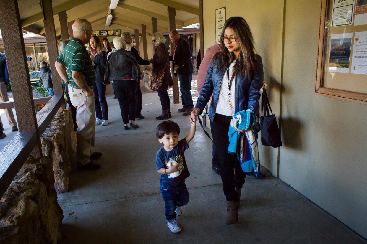 Peruvian sanctuary seeker Ingrid Encalada Latorre walks with her son Anibal into a service where she will introduced to the congregants in 2017, during a worship service at Foothills Unitarian Church in Fort Collins.