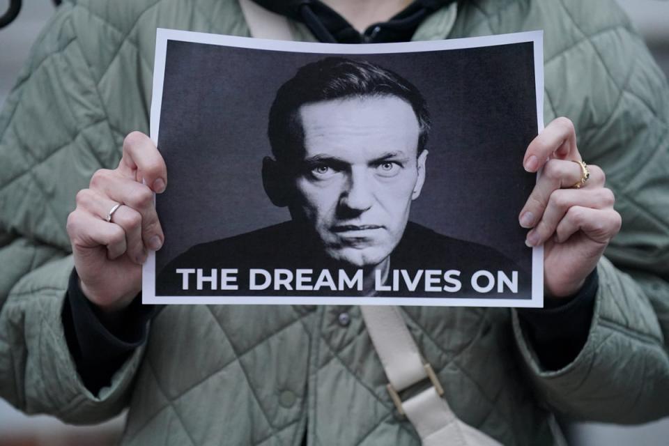 A protester holds a picture of Navalny at a protest opposite the Russian embassy in London (PA Wire)