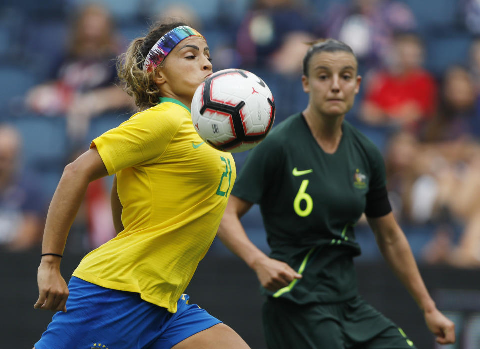 Brazil defender Mônica (21) gets control of the ball as Australia midfielder Chloe Logarzo (6) defends during the first half of the Tournament of Nations soccer match in Kansas City, Kan., Thursday, July 26, 2018. (AP Photo/Colin E. Braley)