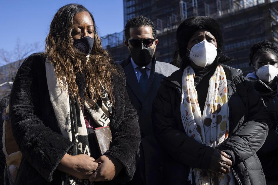 Members of National Action Network pray during a news conference near the scene of shooting in Harlem section of Manhattan on Saturday, Jan. 22, 2022, in New York. New York City police officer Jason Rivera and Officer Wilbert Mora were shot Friday night while answering a call about an argument between a woman and her adult son. Mora, 27, was critically wounded and “fighting for his life” said Mayor Eric Adams on Saturday. (AP Photo/Yuki Iwamura)