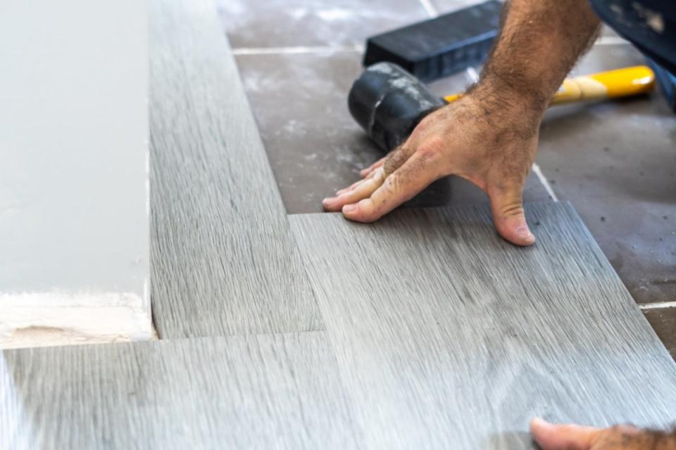 Person installing vinyl flooring