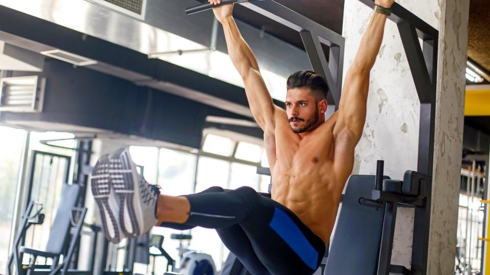 man doing hanging leg raises