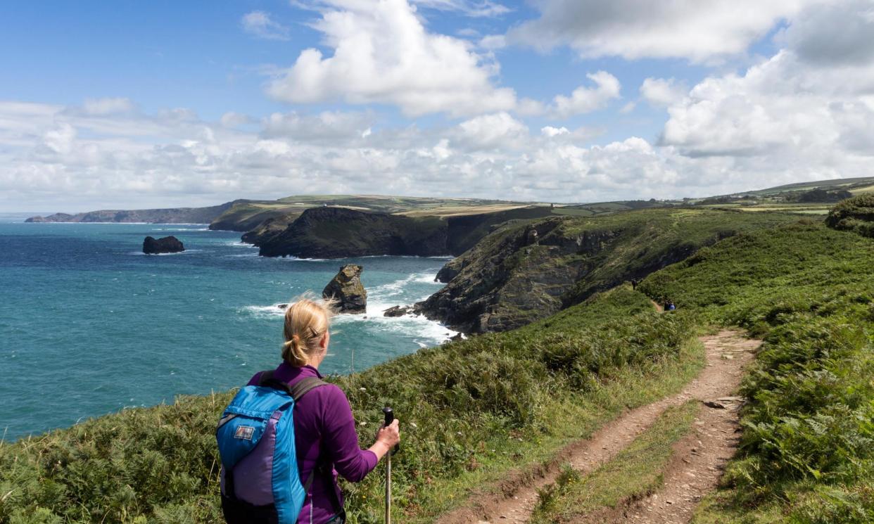 <span>A lone walker on the South West Coast Path between Tintagel and Boscastle in Cornwall.</span><span>Photograph: David Forster/Alamy</span>