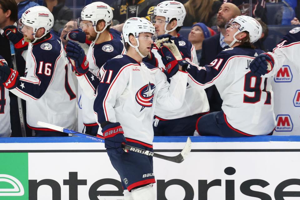 Columbus Blue Jackets center Adam Fantilli (11) is congratulated for his goal against the Buffalo Sabres during the first period of an NHL hockey game Tuesday, Dec. 19, 2023, in Buffalo, N.Y. (AP Photo/Jeffrey T. Barnes)