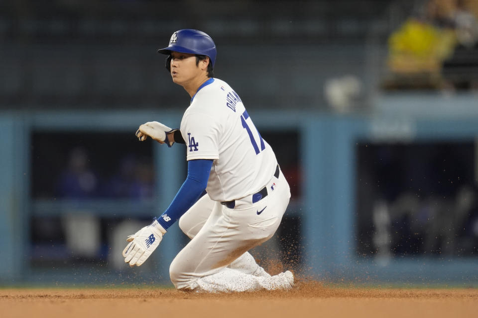 Los Angeles Dodgers' Shohei Ohtani steals second base against the San Diego Padres during the first inning of a baseball game Saturday, April 13, 2024, in Los Angeles. (AP Photo/Marcio Jose Sanchez)