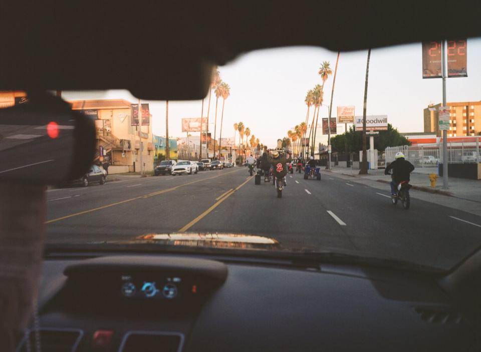 Dirt bikers ride through Los Angeles on a Sunday afternoon.