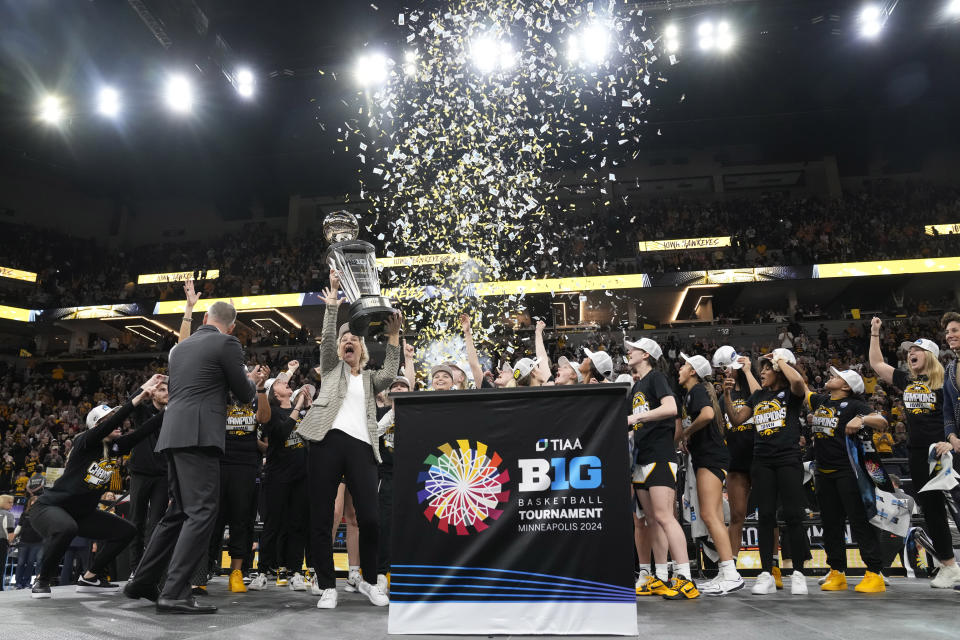Iowa players and coaches celebrate after the overtime win against Nebraska of NCAA college basketball game in the final of the Big Ten women's tournament Sunday, March 10, 2024, in Minneapolis. (AP Photo/Abbie Parr)