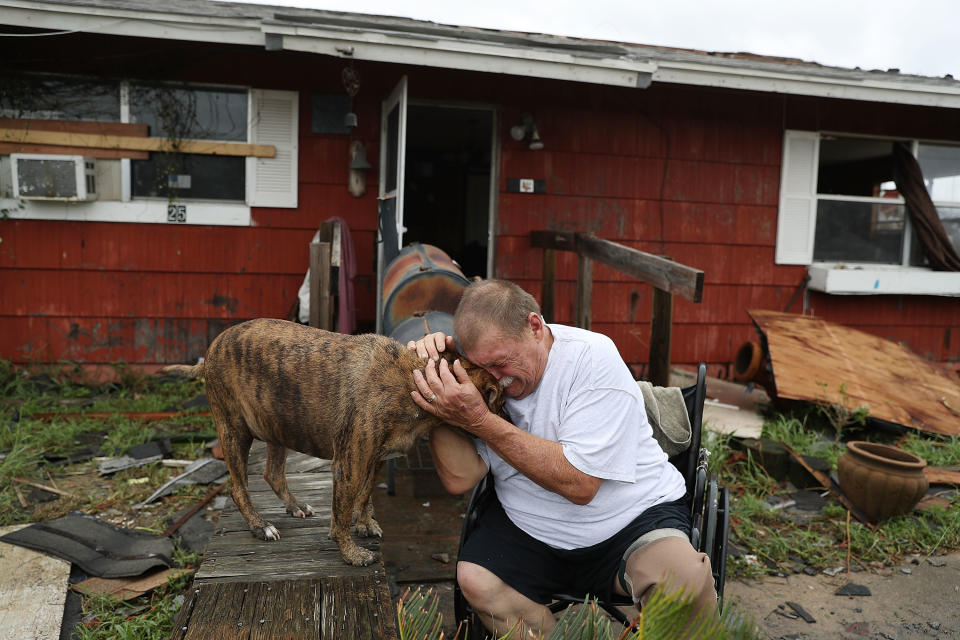 <p>Steve Culver cries with his dog Otis as he talks about what he said was the, “most terrifying event in his life,” when Hurricane Harvey blew in and destroyed most of his home while he and his wife took shelter there on Aug. 26, 2017 in Rockport, Texas. (Photo: Joe Raedle/Getty Images) </p>