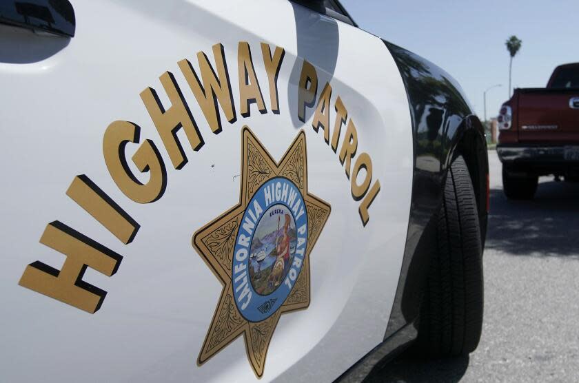 FILE - In this April 23, 2020, file photo, a California Highway Patrol officer stops a motorist in Anaheim, Calif. California Attorney General Rob Bonta announced, Thursday, July 8, 2021, that six officers working out of East Los Angeles, have been criminally charged for exaggerating their overtime hours while providing protection for state highway workers during road construction projects. (AP Photo/Chris Carlson, File)