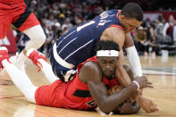 Toronto Raptors forward Pascal Siakam, bottom, grabs a loose ball from Houston Rockets forward Jabari Smith Jr. during the first half of an NBA basketball game, Friday, Feb. 3, 2023, in Houston. (AP Photo/Eric Christian Smith)