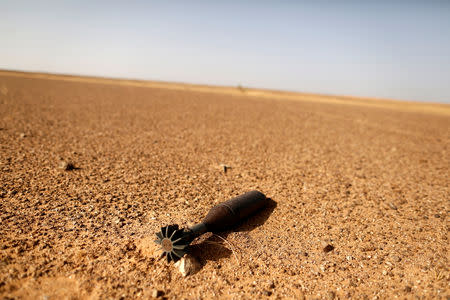 FILE PHOTO: A rocket is pictured near an earth wall that separates areas controlled by Morocco and the Polisario Front in Western Sahara, September 10, 2016. REUTERS/ Zohra Bensemra/File Photo