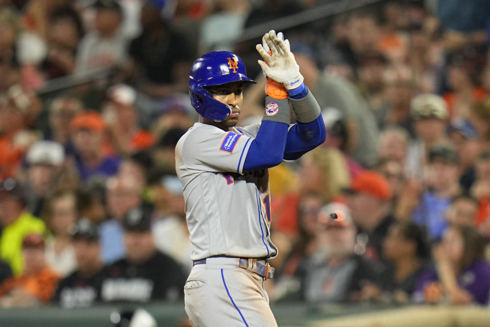 New York Mets' Francisco Lindor gestures after hitting a two-run single to score Rafael Ortega and Jeff McNeil in the sixth inning of a baseball game against the Baltimore Orioles, Friday, Aug. 4, 2023, in Baltimore. (AP Photo/Julio Cortez)