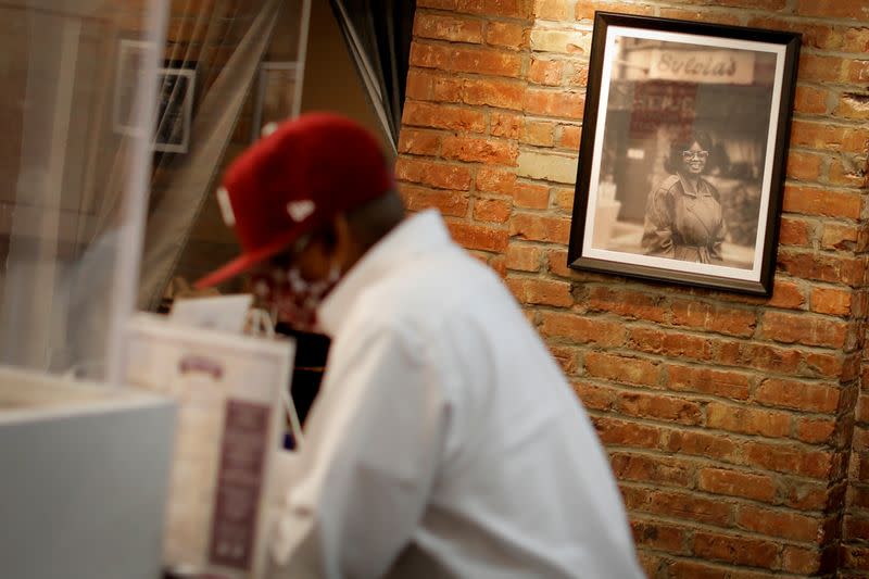 Man orders from takeout menu inside Sylvia's Restaurant in Harlem in New York