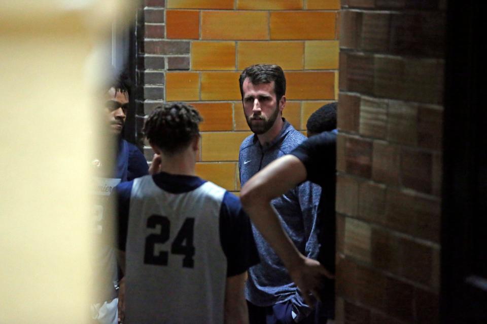 La Lumiere boys basketball head coach Pat Holmes addresses his team in the hallway during an open practice Thursday, Nov. 9, 2023, at the La Porte Civic Auditorium.