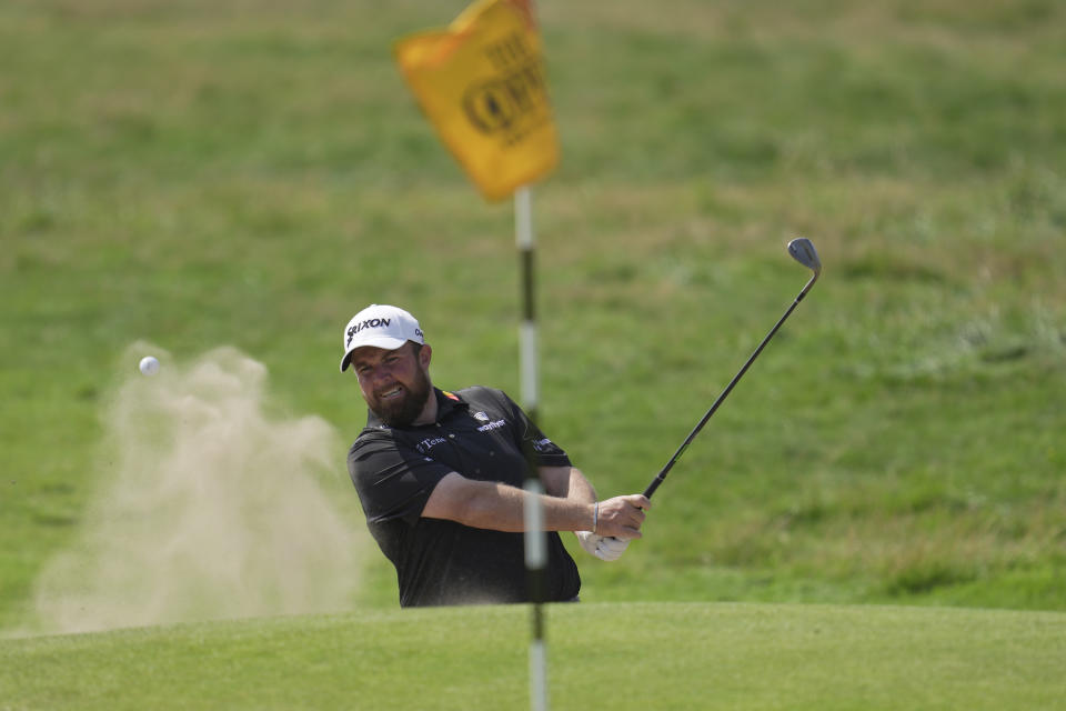 Ireland's Shane Lowry hits out of a bunker on the 18th green on the first day of the British Open Golf Championships at the Royal Liverpool Golf Club in Hoylake, England, Thursday, July 20, 2023. (AP Photo/Kin Cheung)